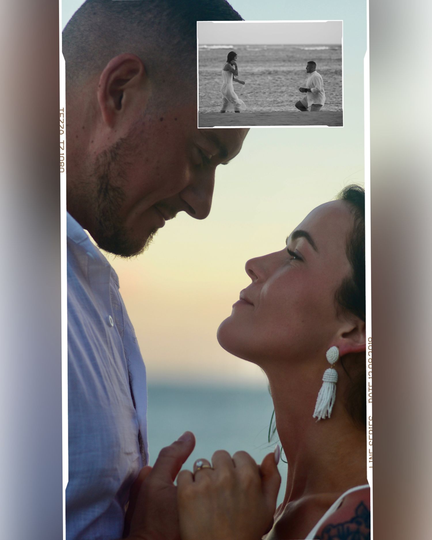 A couple embraces on a beach at sunset with palm trees and ocean waves in the background.