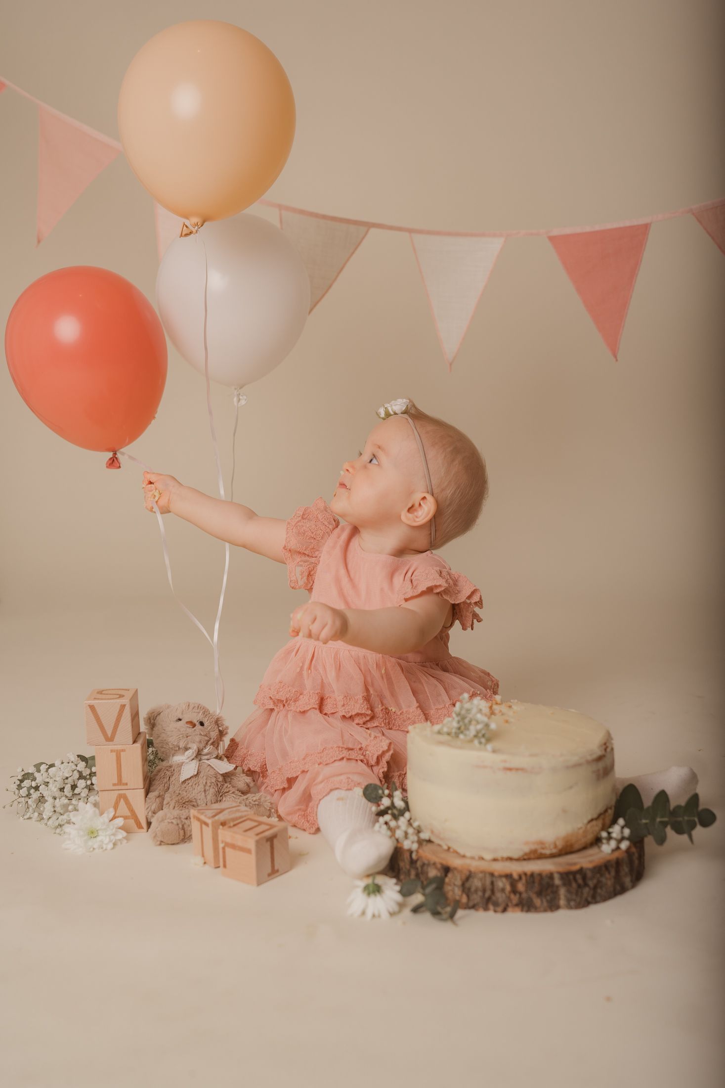 A series of newborn baby photos showing sleeping infants on soft beige blankets and textured backgrounds.