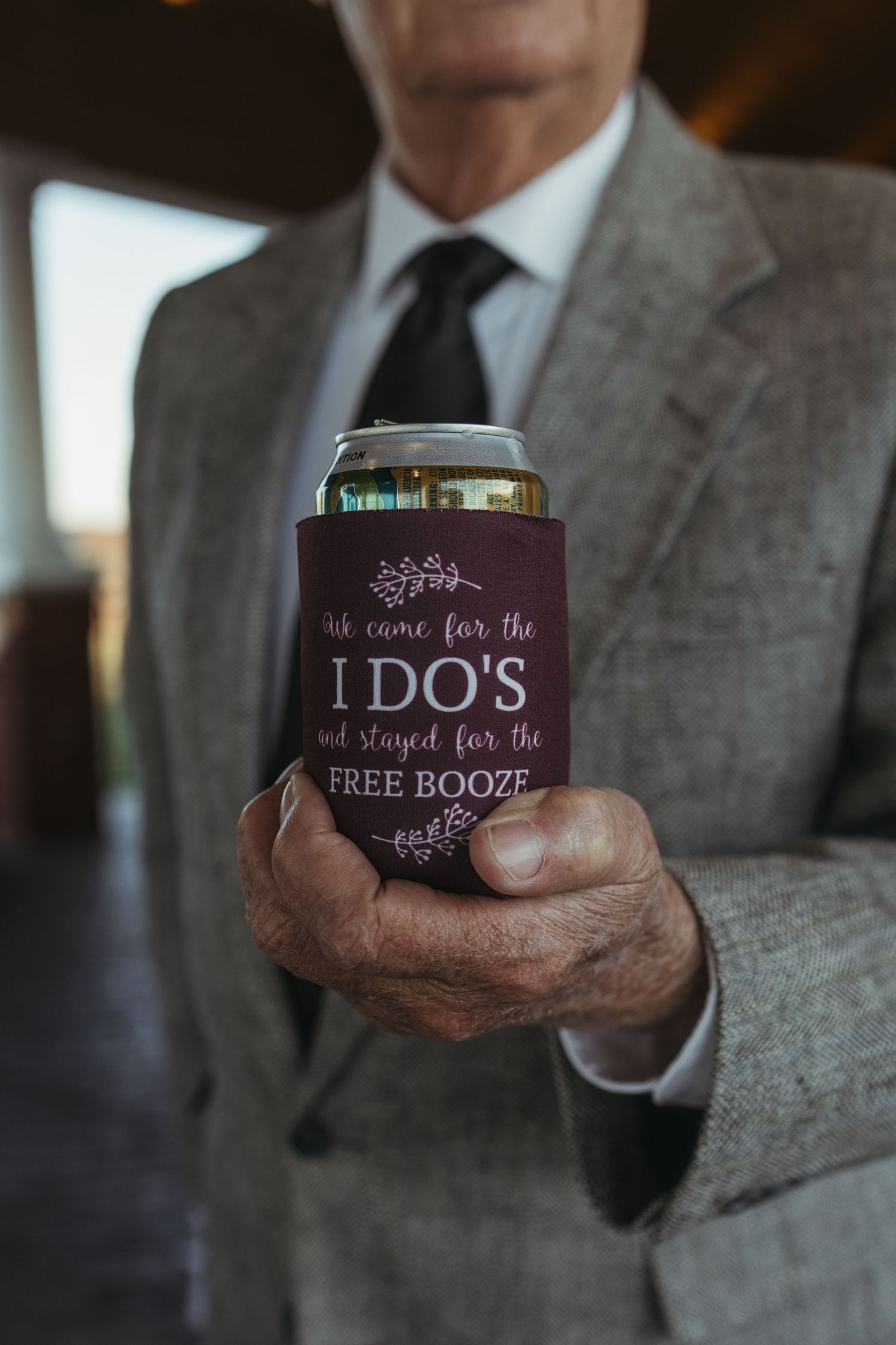 A series of close-up shots showing hands holding custom wedding koozies with text about the couple's special day.