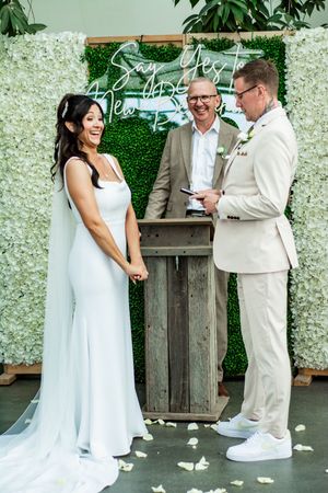 Wedding ceremony sequence showing joyful moments against a floral backdrop.