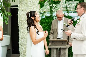 Intimate wedding moments captured against a backdrop of greenery and white flowers.