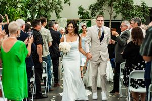 Wedding guests celebrate and dance together during an outdoor reception party.