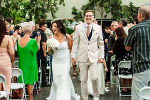 Wedding celebration with guests mingling in an outdoor garden setting.