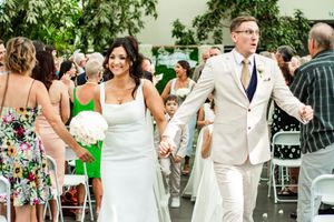 Wedding guests enjoying the celebration on a patio with greenery.