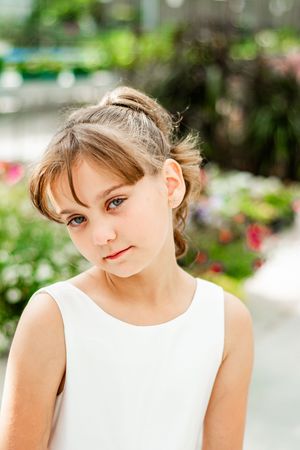 Close-up portrait series in a garden setting with soft natural lighting.