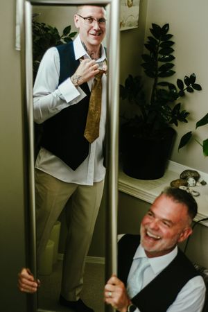 Candid moments of laughter and fun during wedding day preparations.