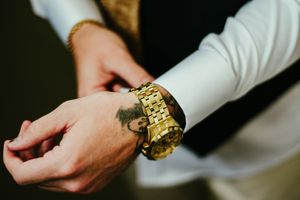 Close-up of hands adjusting formal attire accessories.