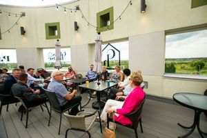 Reception venue with tables and chairs set up for guests in a spacious room.