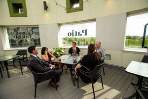 Contemporary event space with string lights and casual seating areas.