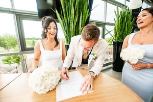 Wedding celebration details showing decorative elements and floral arrangements in a bright indoor venue.