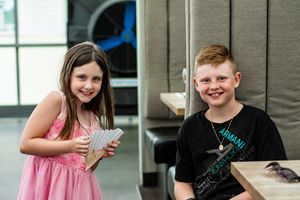 Children enjoying themselves at a wedding reception in casual attire.
