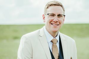 A series of joyful expressions and interactions at a formal event with people wearing light colored suits.