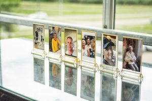 Modern glass display wall showcasing wedding photos and memories.
