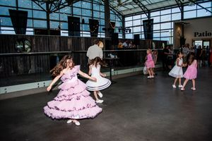 Dance floor at a wedding reception showing guests enjoying themselves in an elegant indoor venue.