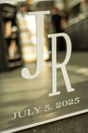 Close-up detail shot of wedding date text reading July 5, 2025.