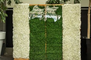 Elegant white floral wall display creates a stunning wedding ceremony backdrop.