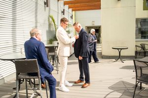 Wedding celebration candid moments on an outdoor patio with modern furniture.