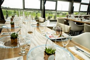 Elegant table settings with wine glasses and place settings at an upscale event venue.