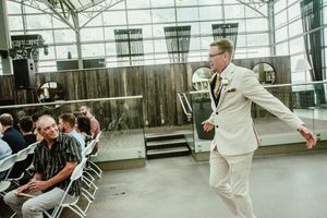 Wedding guests enjoying a casual moment in a modern indoor-outdoor space.
