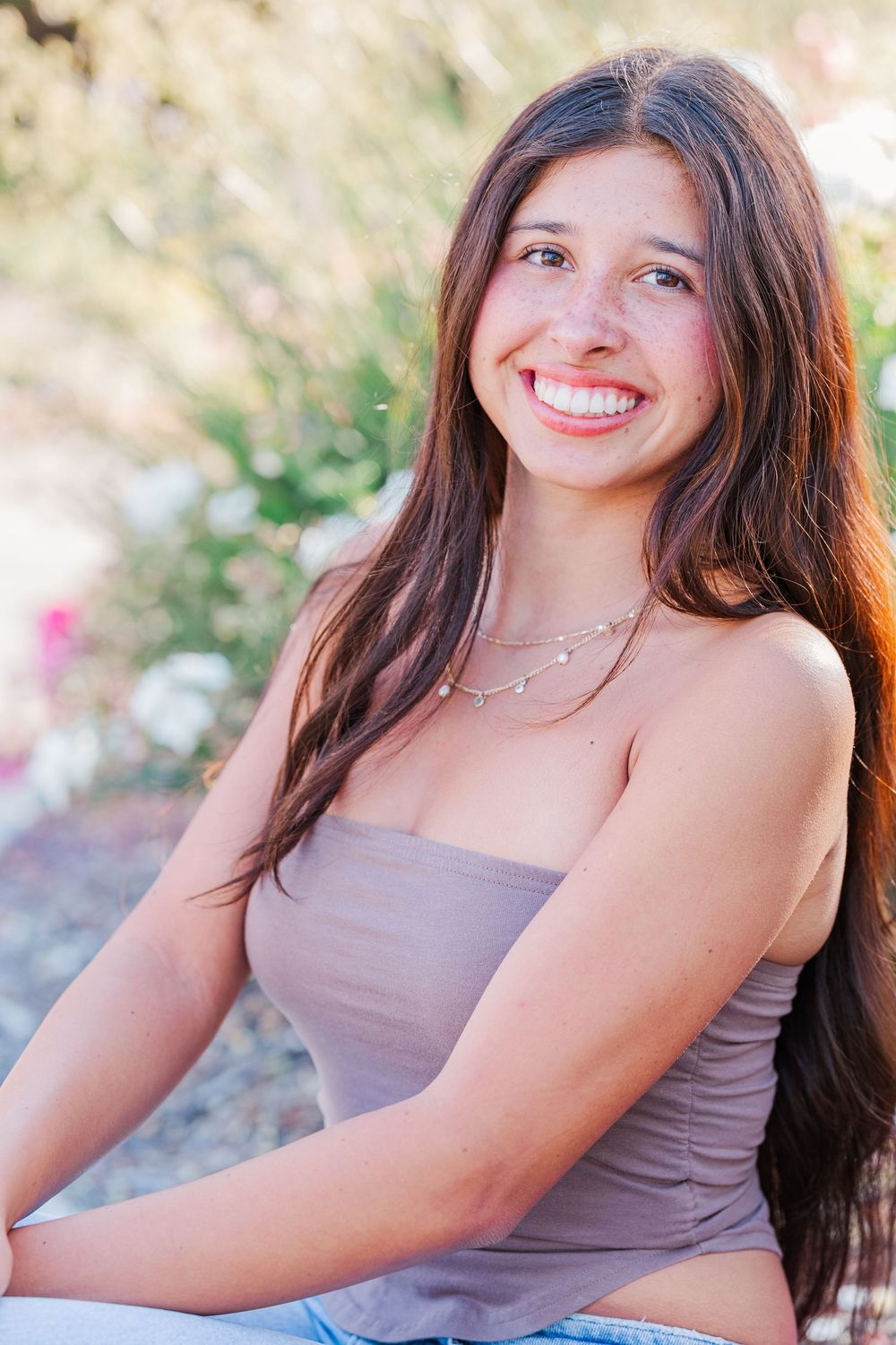 Portrait photos showing someone in a mauve top against a natural outdoor background.