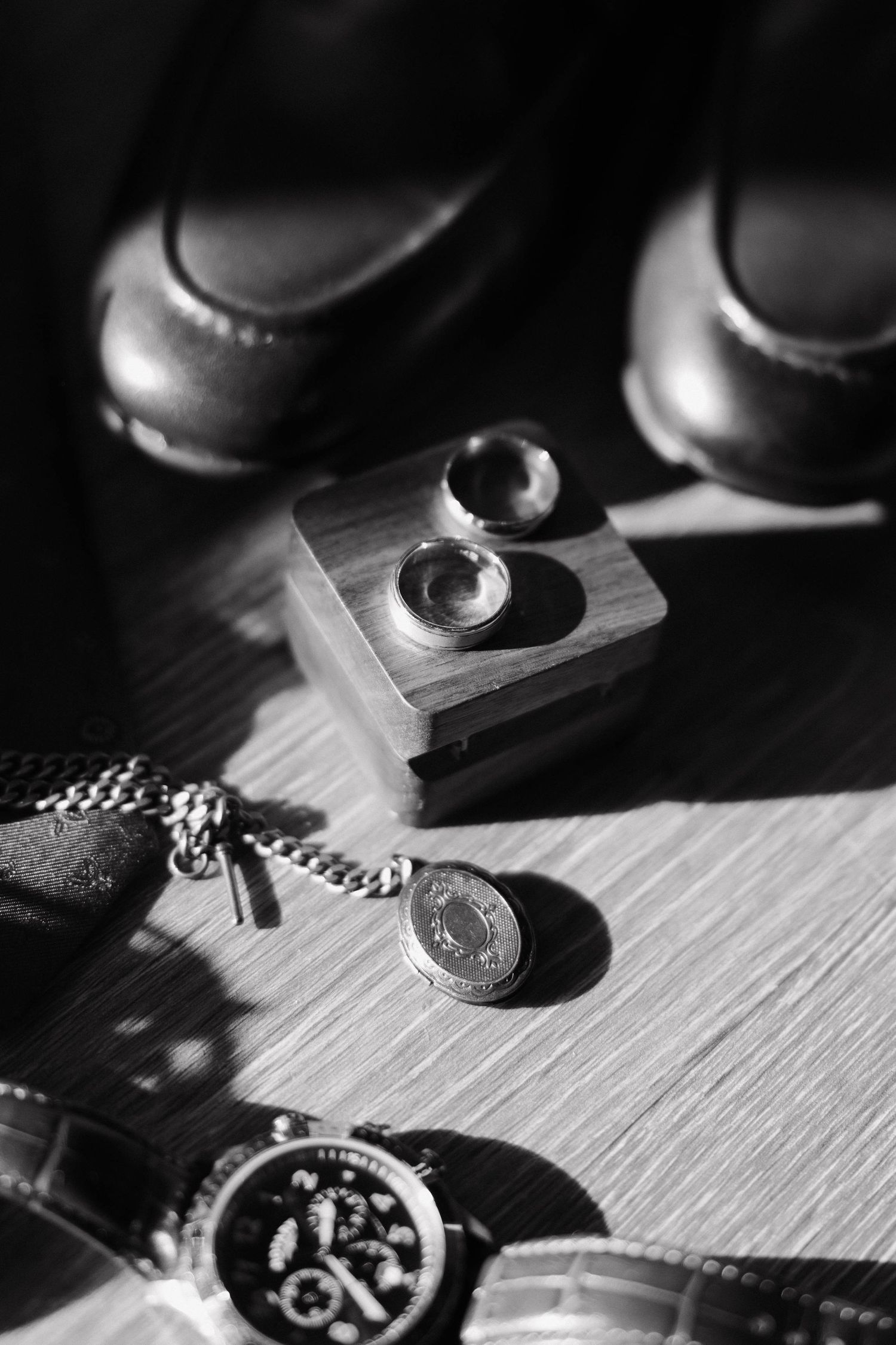 Black and white close-up detail shots of luxury watches and jewelry pieces.
