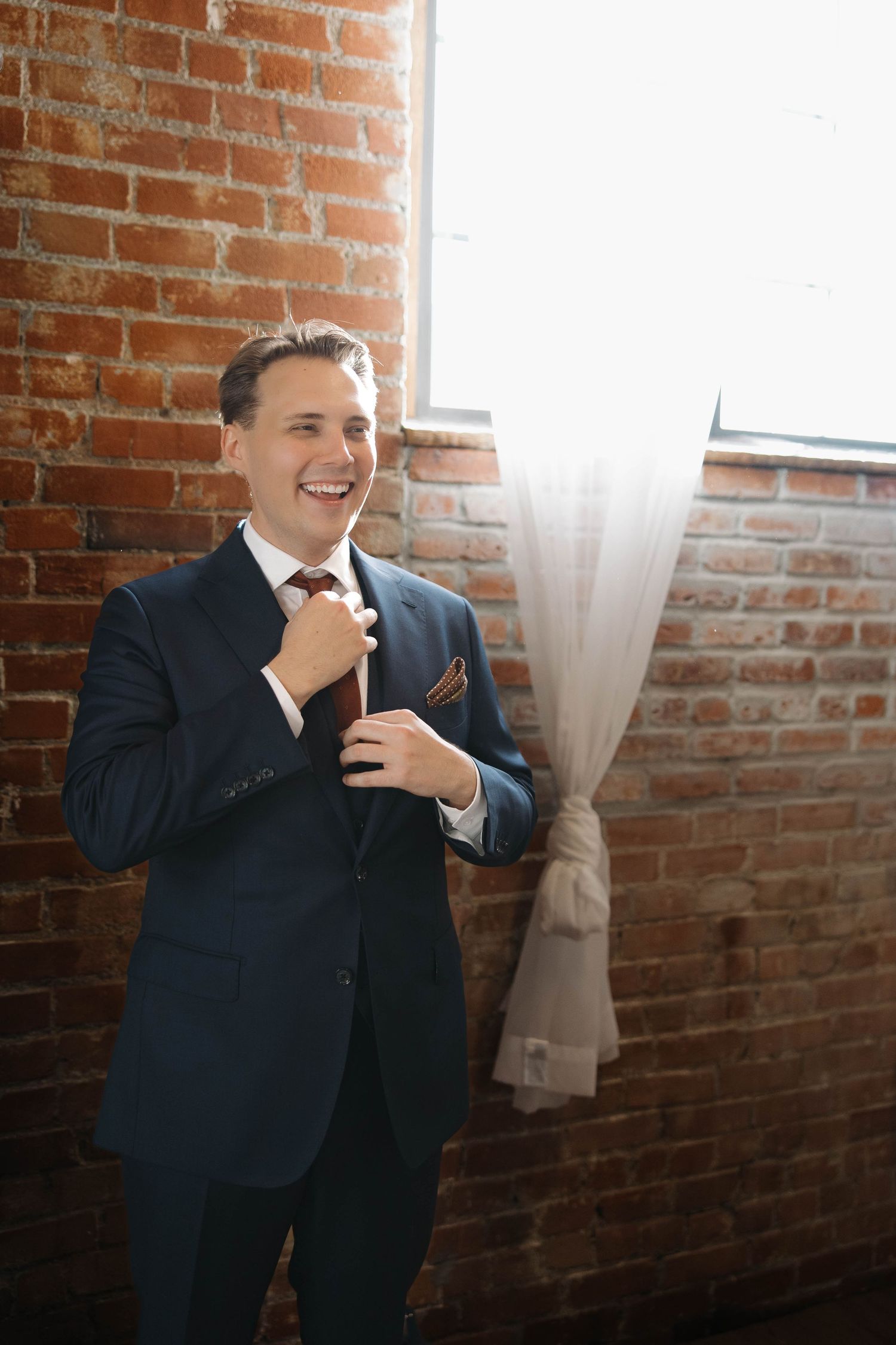 A series of candid moments in a rustic brick-walled setting showing expressions of joy and laughter.