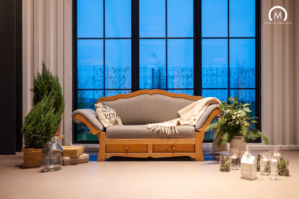 Modern luxury apartment interior with floor-to-ceiling windows showcasing city views at dusk and contemporary furniture.