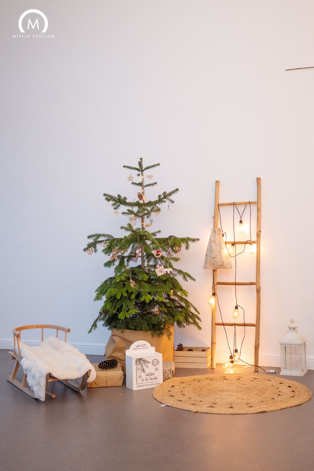 A progressive series of photos showing a Christmas tree setup with wooden furniture and string lights against a white wall.