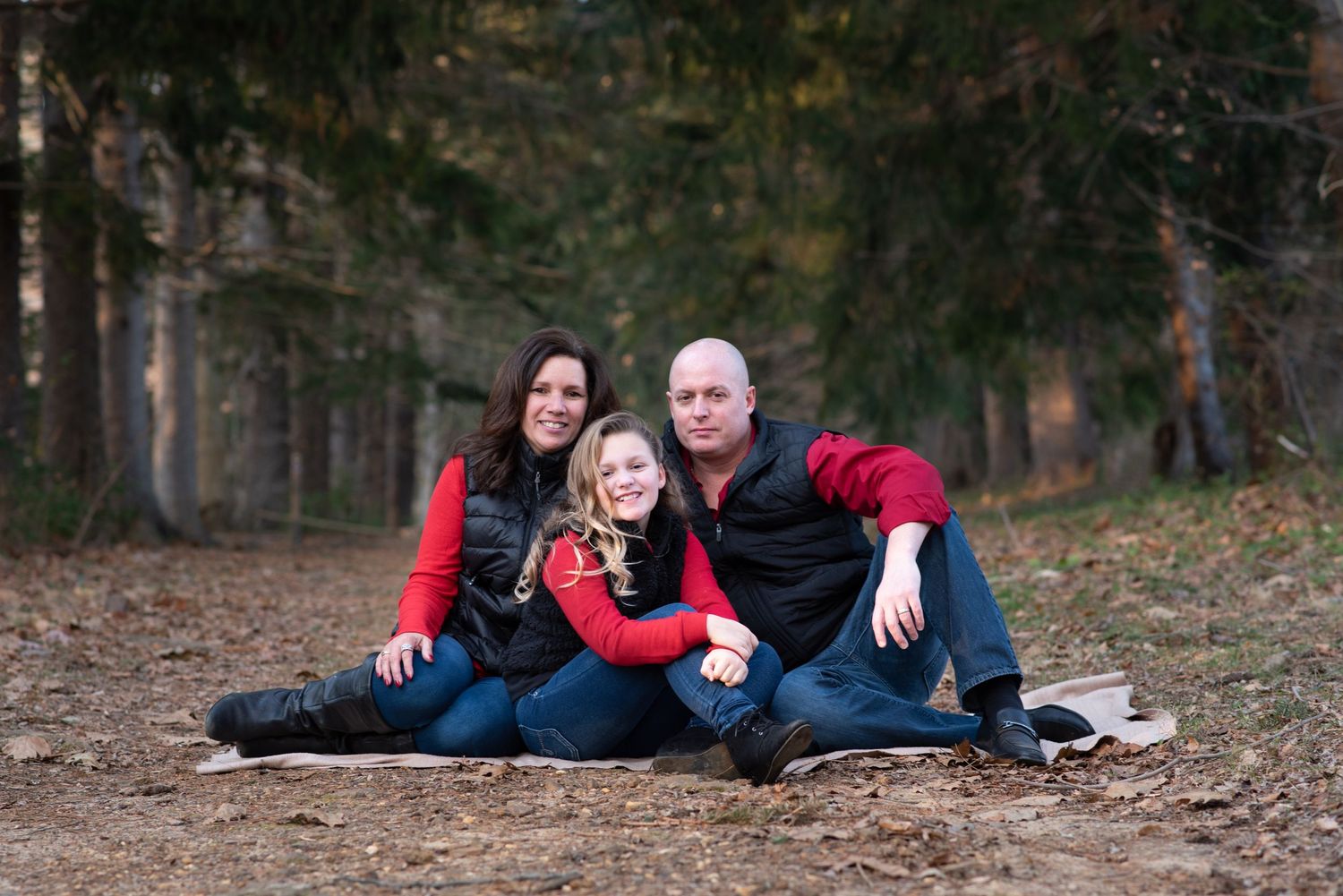 Family group photo session in a pine forest during golden hour in Monmouth County NJ