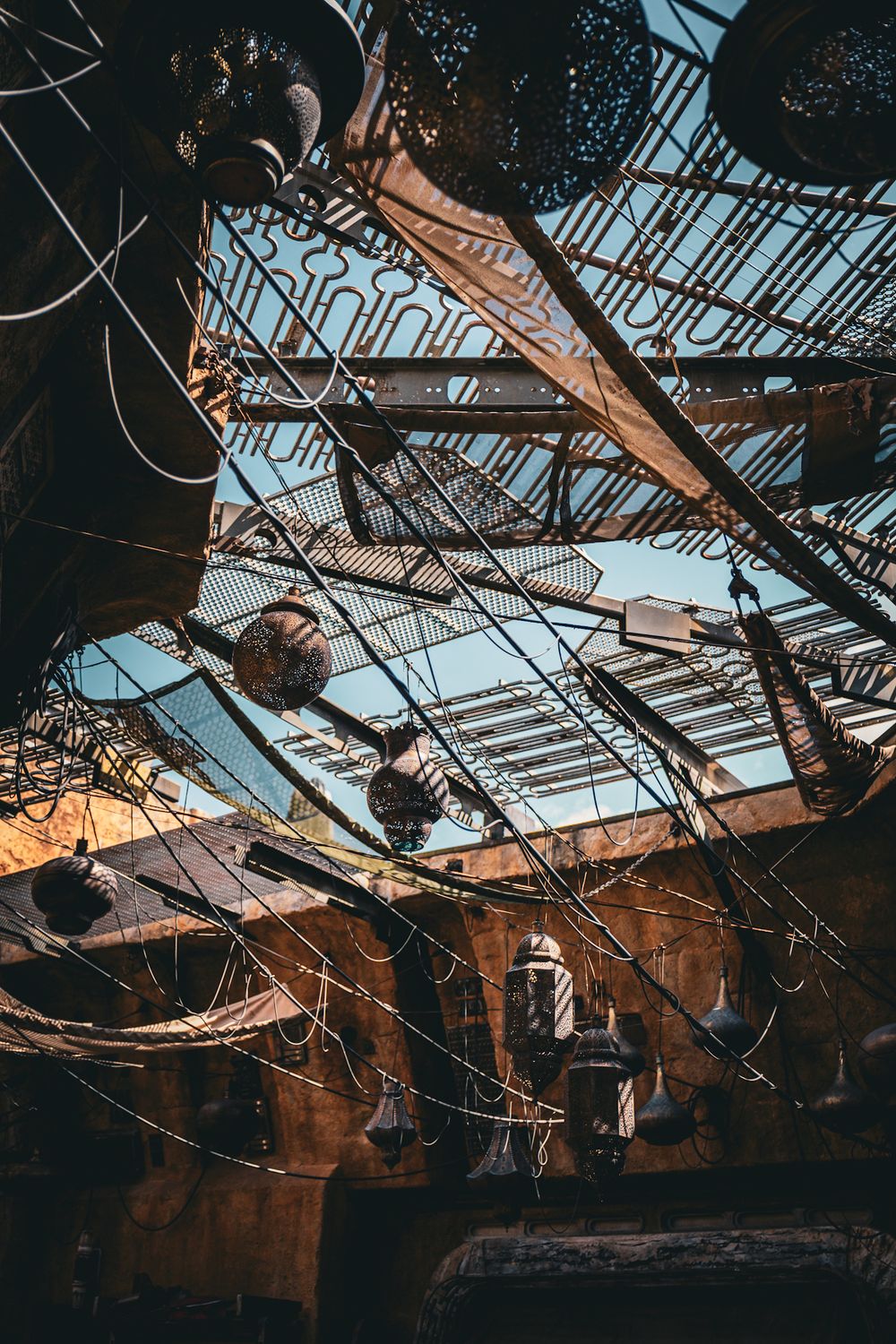 Damaged glass ceiling with exposed metal framework in an abandoned or destroyed building.