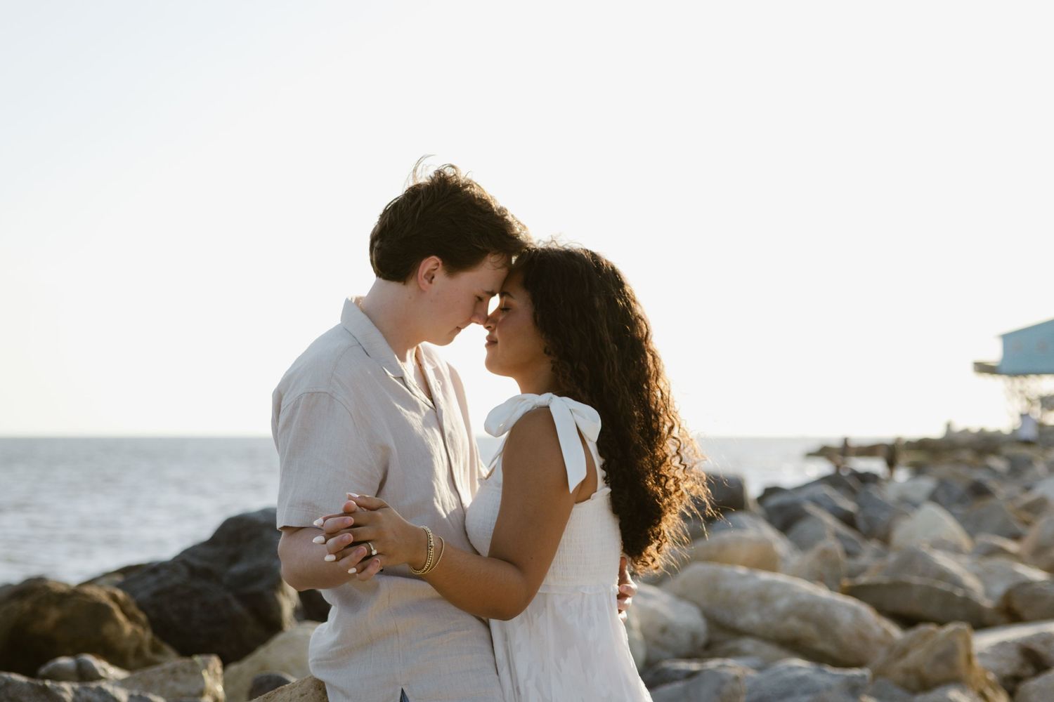 Evening engagement photos on a rocky beach in Florida.