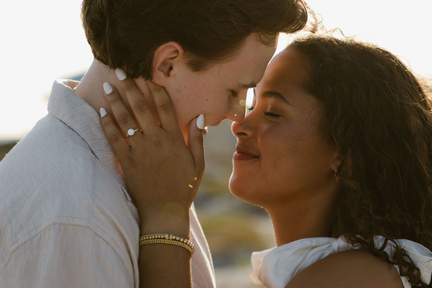 Evening golden hour engagement photos on a rocky beach in Florida.