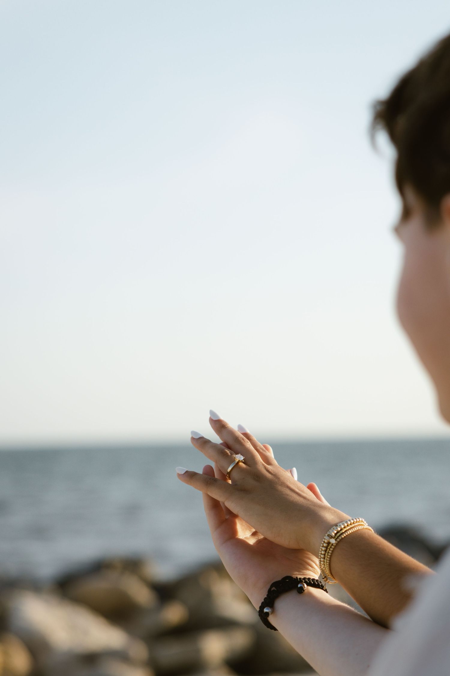 Evening, warm, bright engagement photos on a the rocky coast of Florida.