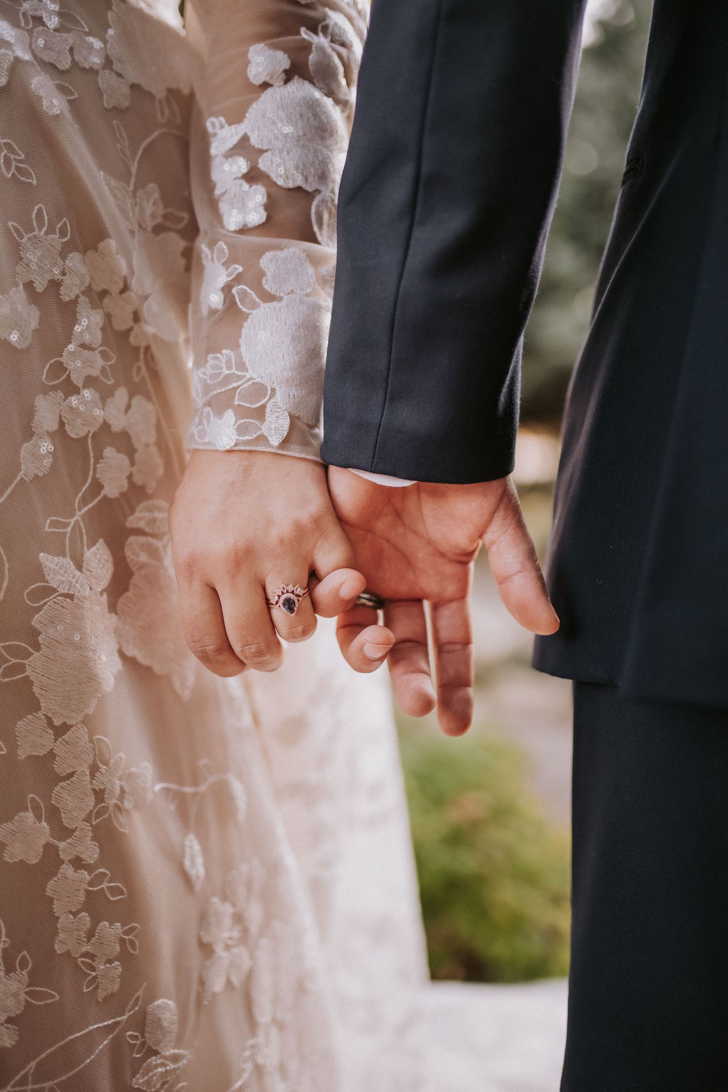 Close-up photo of bride and groom holding hands. Small weddings in New Mexico. Intimate wedding venues. Albuquerque Garden Center weddings.