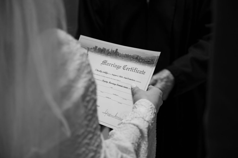 A close-up view of a marriage certificate being signed.