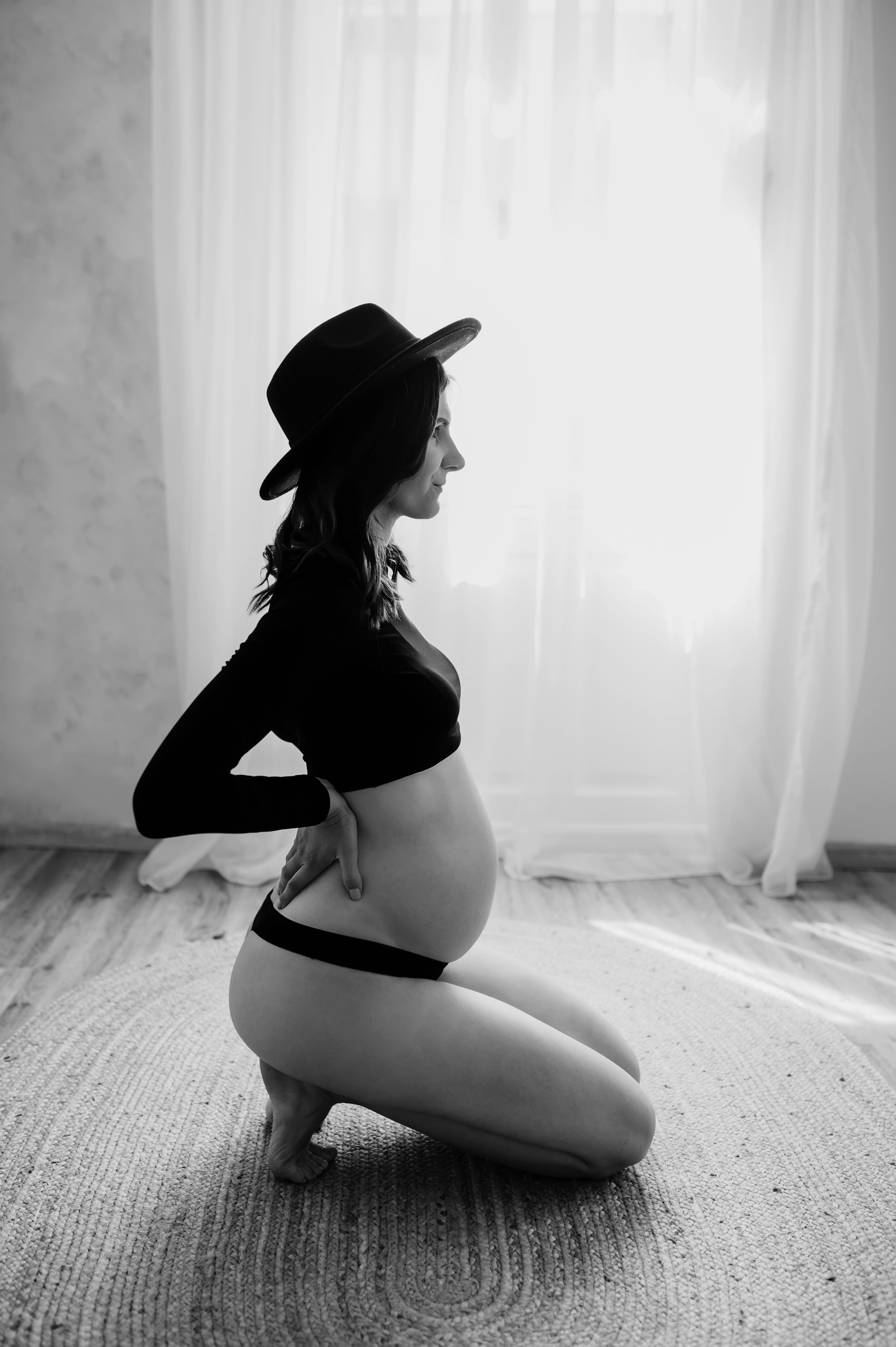Artistic black and white photo sequence showing silhouette figure in various seated poses against bright window light.