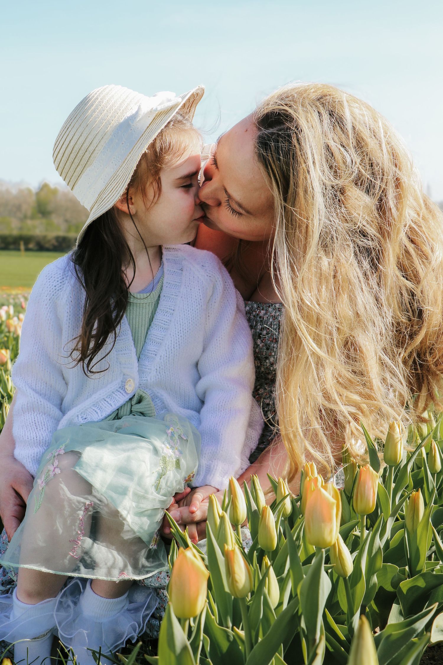 family moments shared among colorful tulips in a spring garden. Coventry and Warwickshire Photographer. Mothers Day Mini Sessions