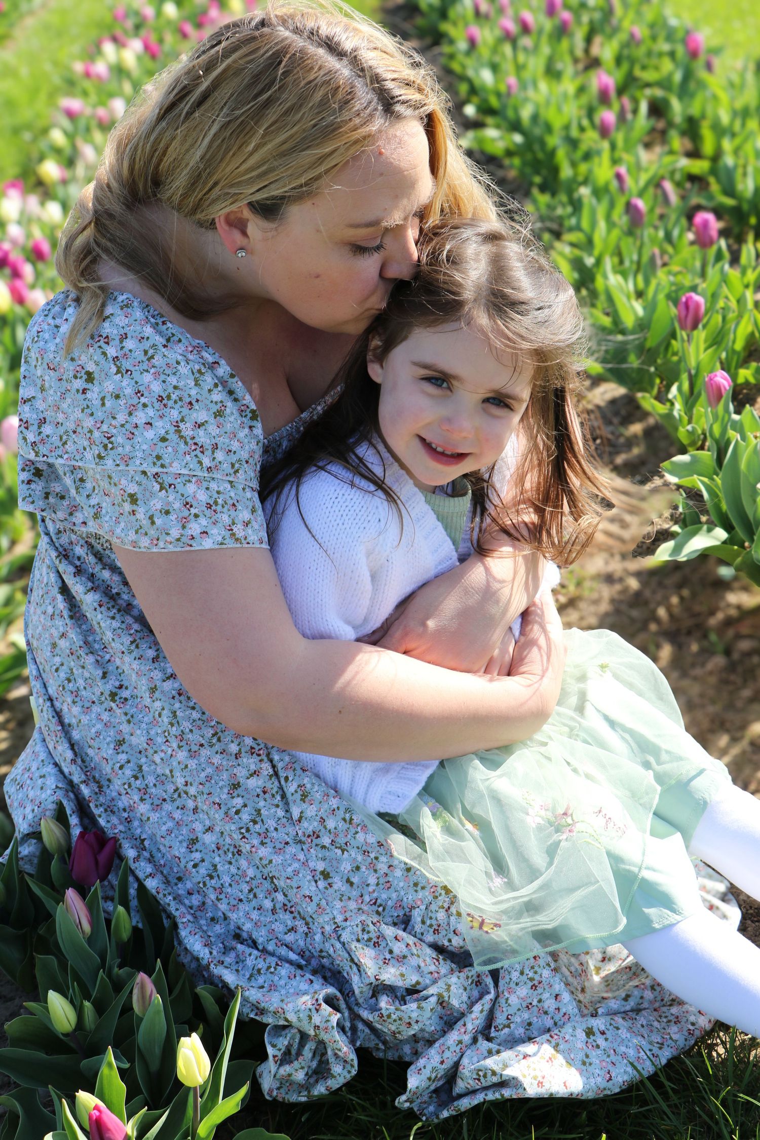 family moments shared among colorful tulips in a spring garden. Coventry and Warwickshire Photographer. Mothers Day Mini Sessions