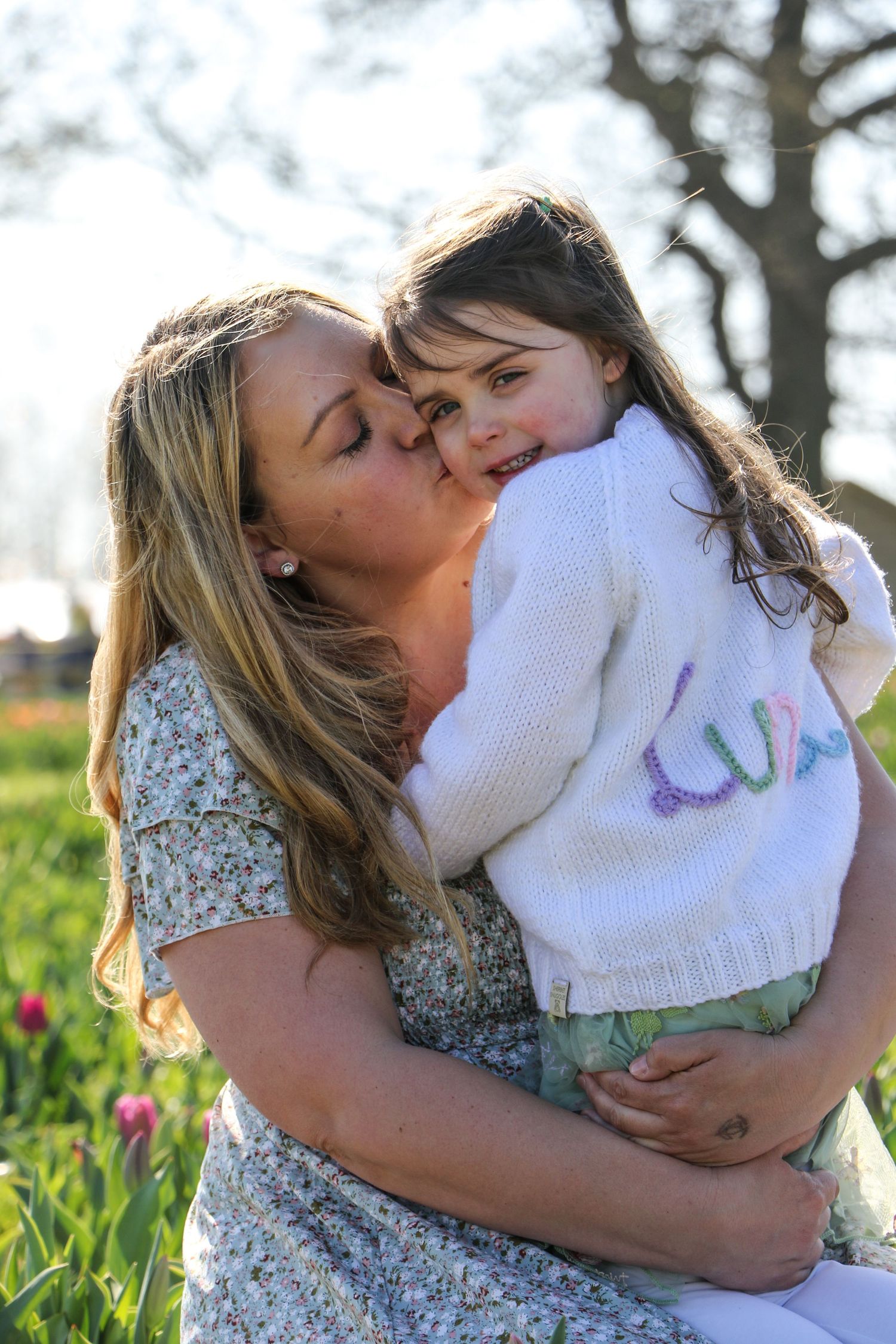 family moments shared among colorful tulips in a spring garden. Coventry and Warwickshire Photographer. Mothers Day Mini Sessions