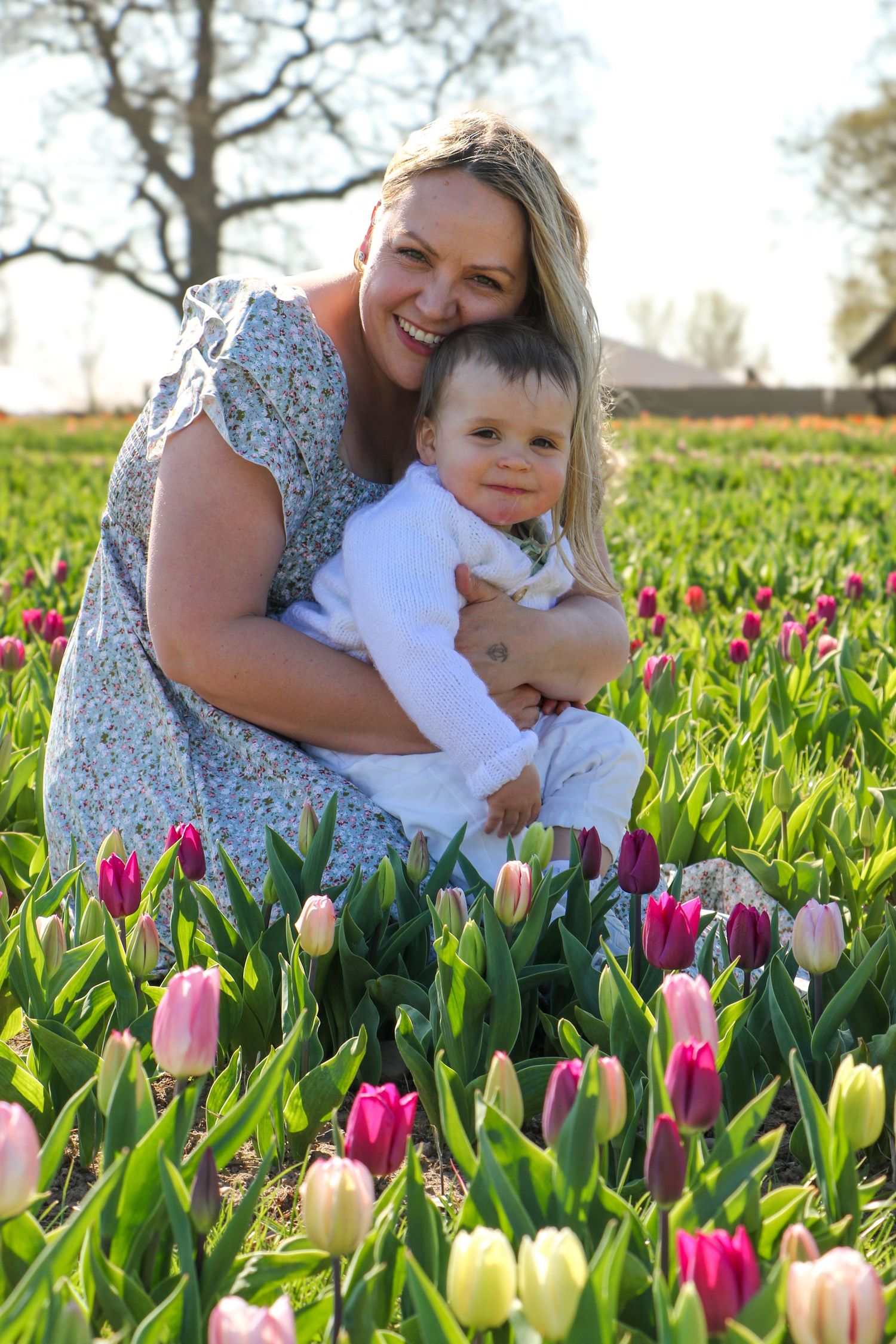 family moments shared among colorful tulips in a spring garden. Coventry and Warwickshire Photographer. Mothers Day Mini Sessions
