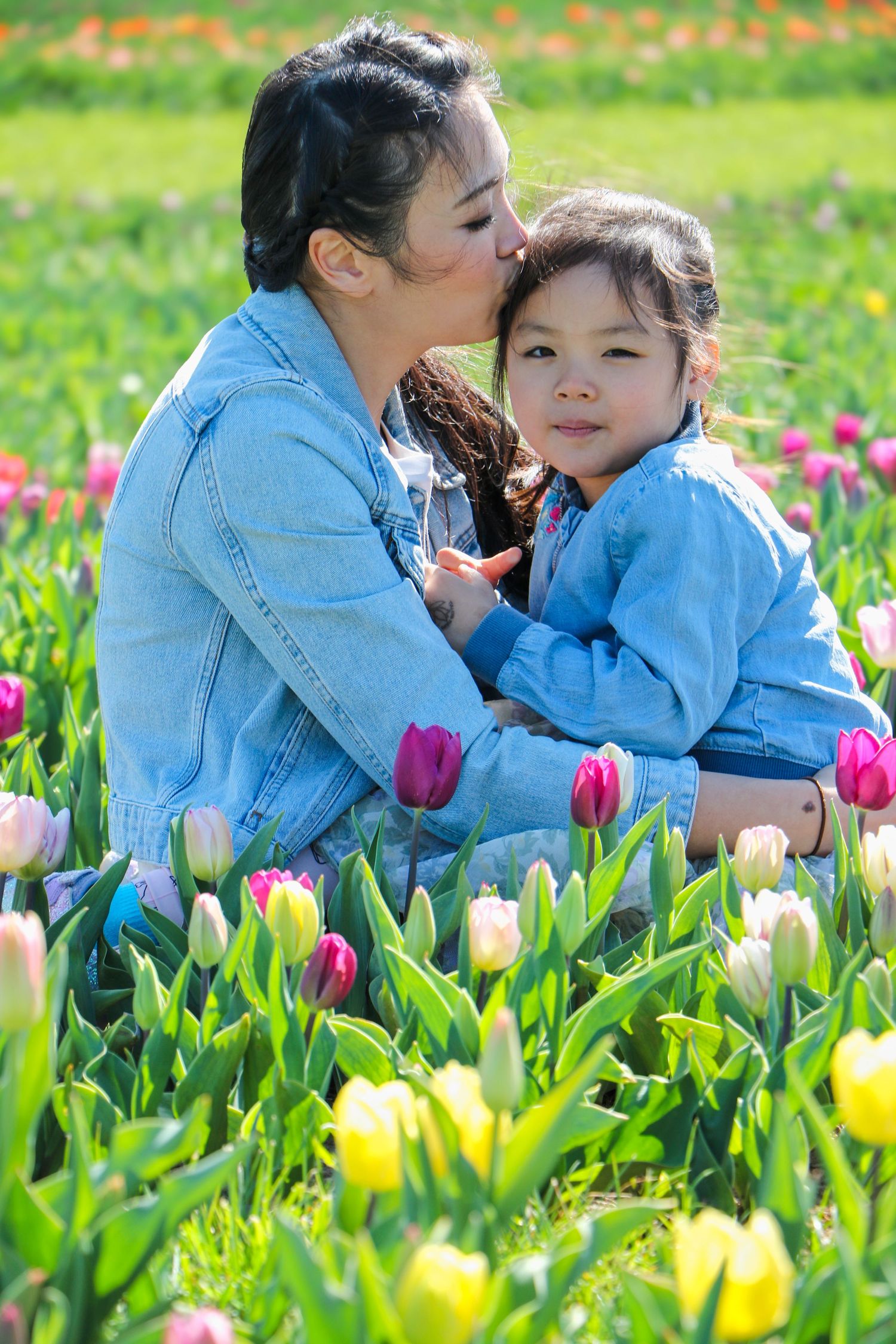 family moments shared among colorful tulips in a spring garden. Coventry and Warwickshire Photographer. Mothers Day Mini Sessions