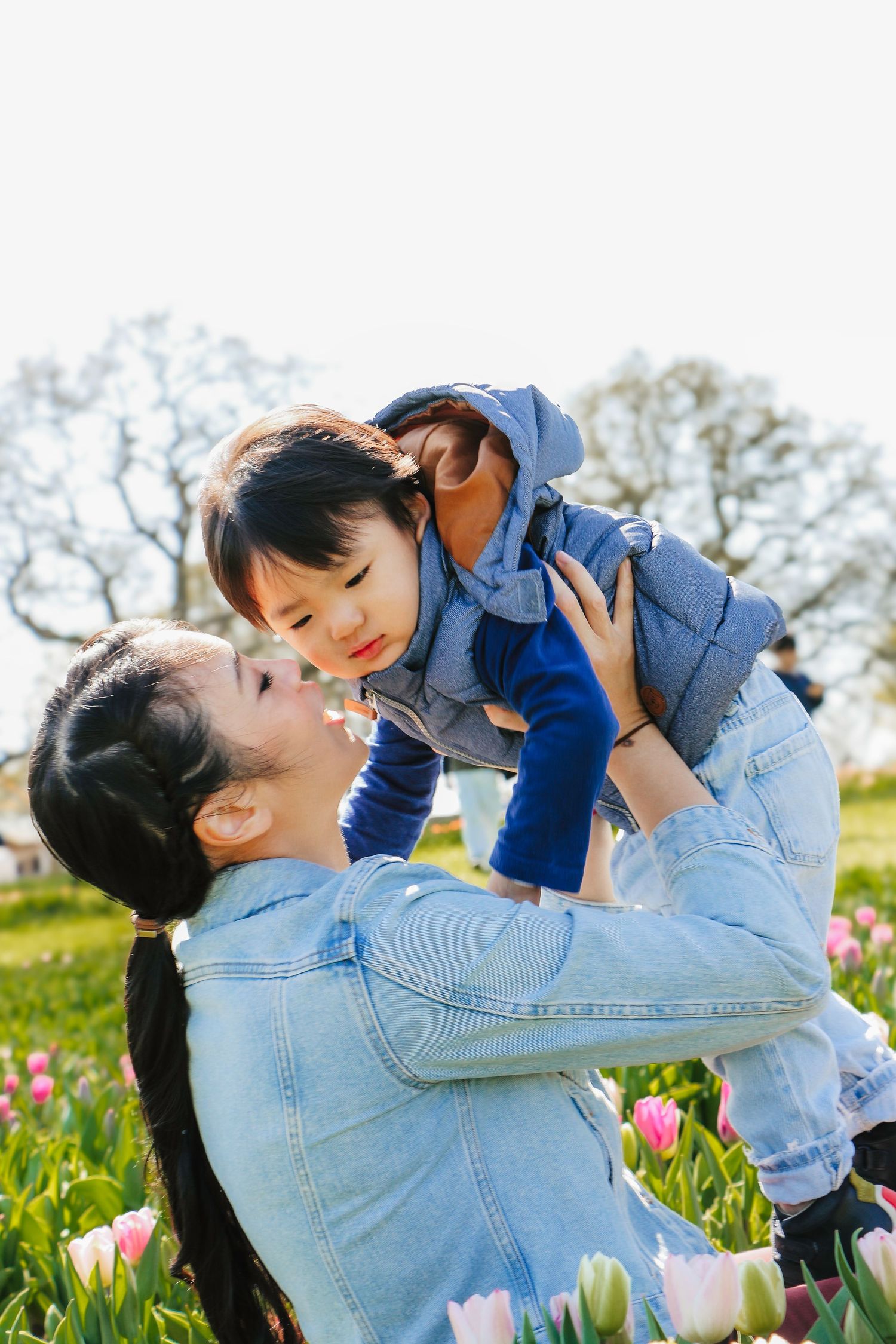 family moments shared among colorful tulips in a spring garden. Coventry and Warwickshire Photographer. Mothers Day Mini Sessions