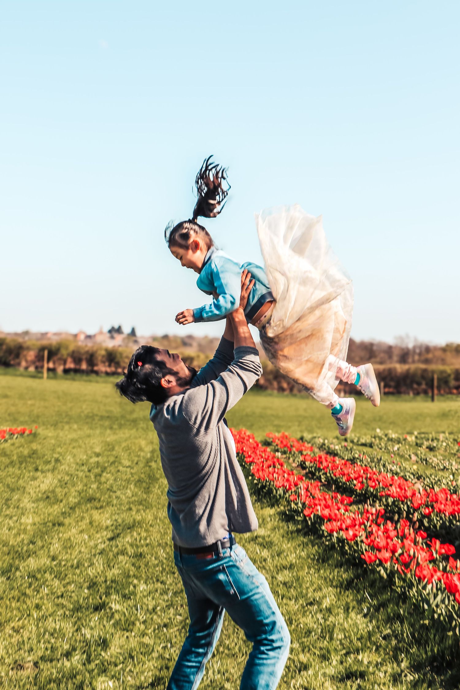 family moments shared among colorful tulips in a spring garden. Coventry and Warwickshire Photographer. Mothers Day Mini Sessions