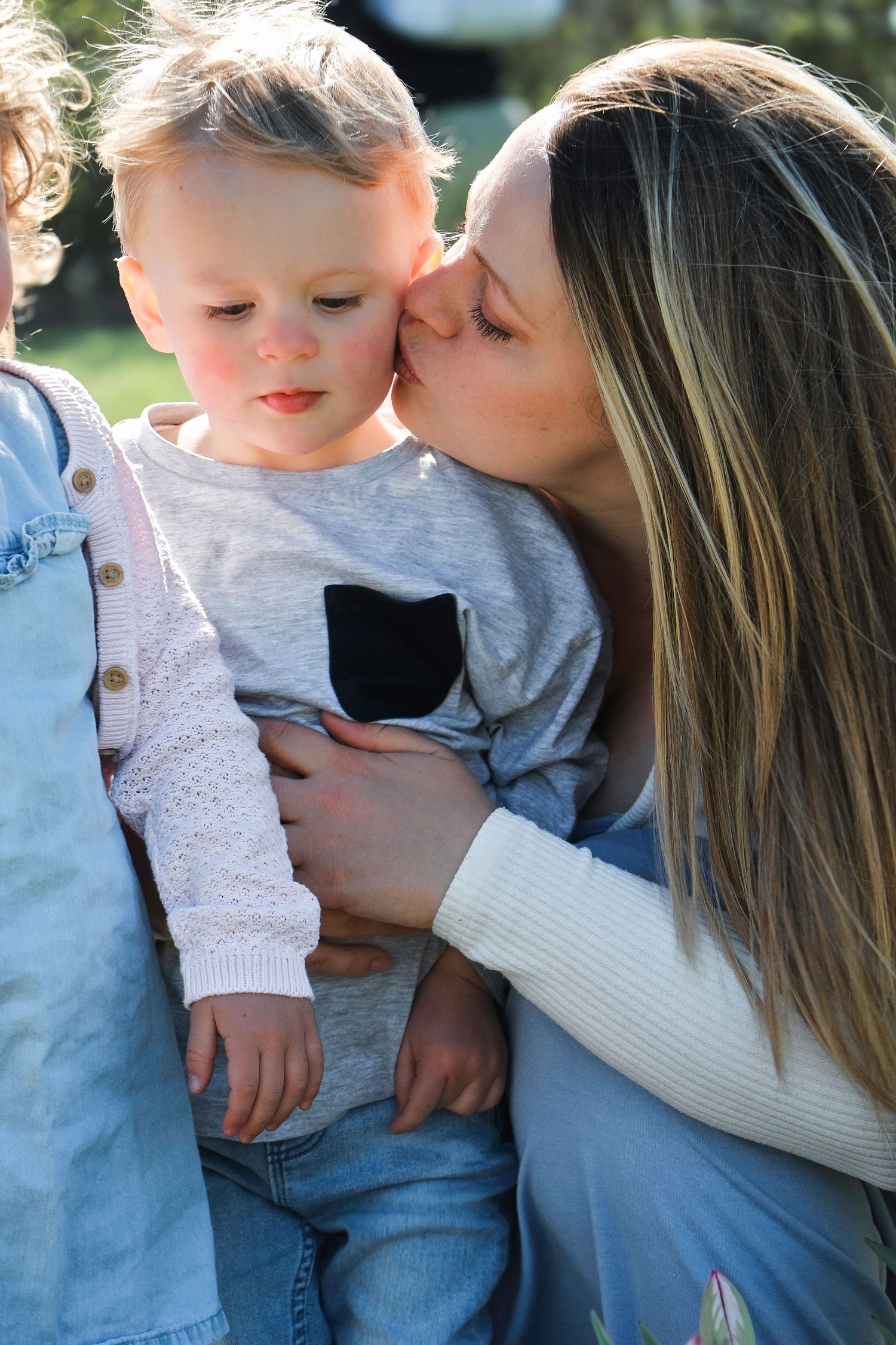 family moments shared among colorful tulips in a spring garden. Coventry and Warwickshire Photographer. Mothers Day Mini Sessions