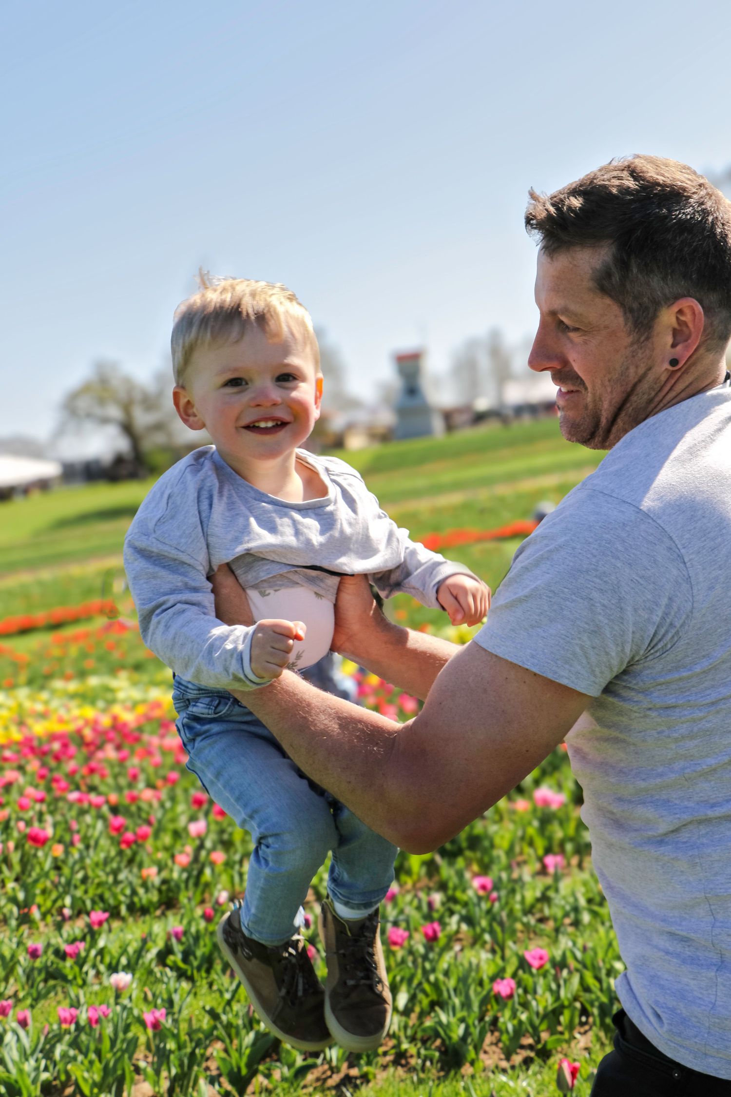 family moments shared among colorful tulips in a spring garden. Coventry and Warwickshire Photographer. Mothers Day Mini Sessions