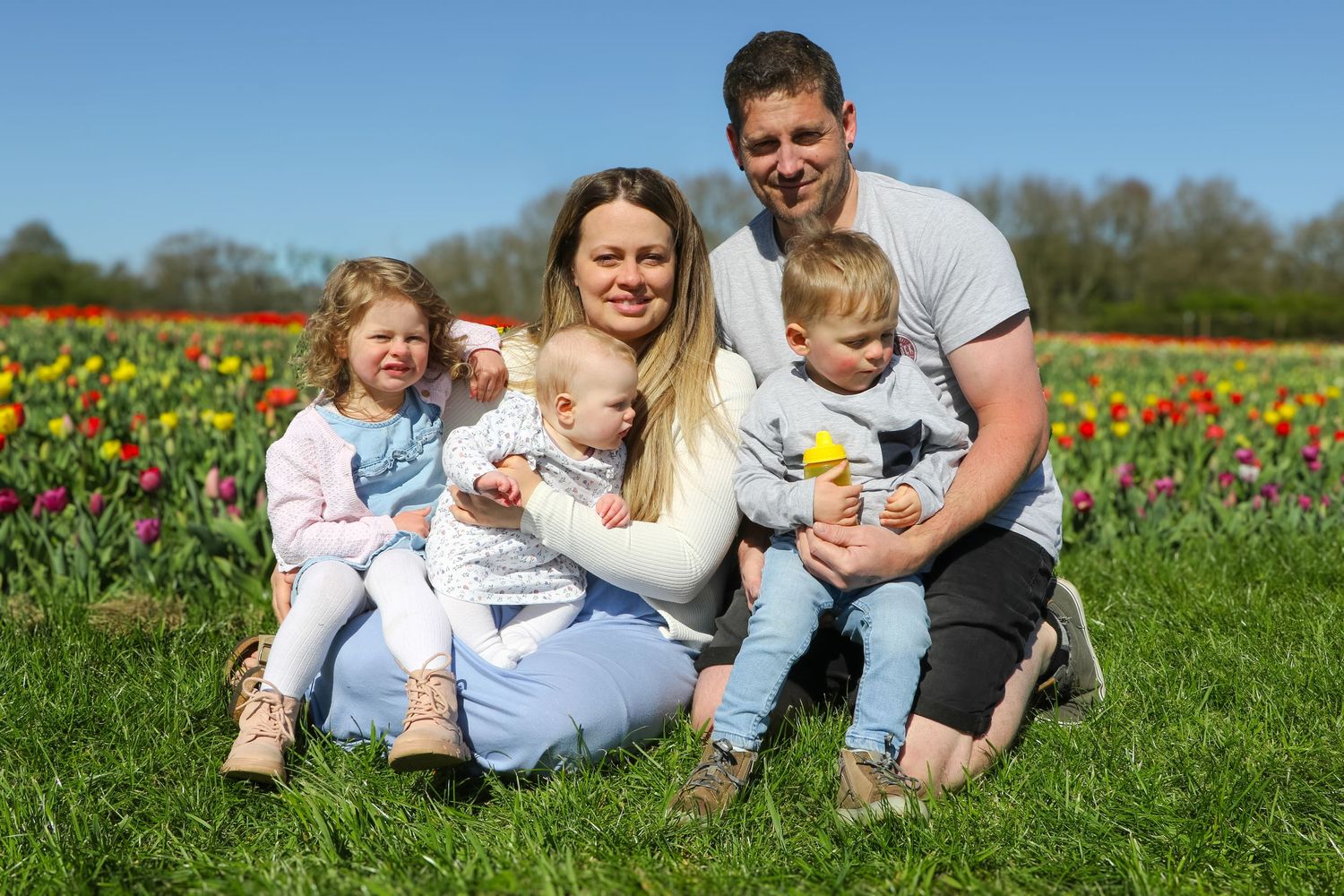family moments shared among colorful tulips in a spring garden. Coventry and Warwickshire Photographer. Mothers Day Mini Sessions