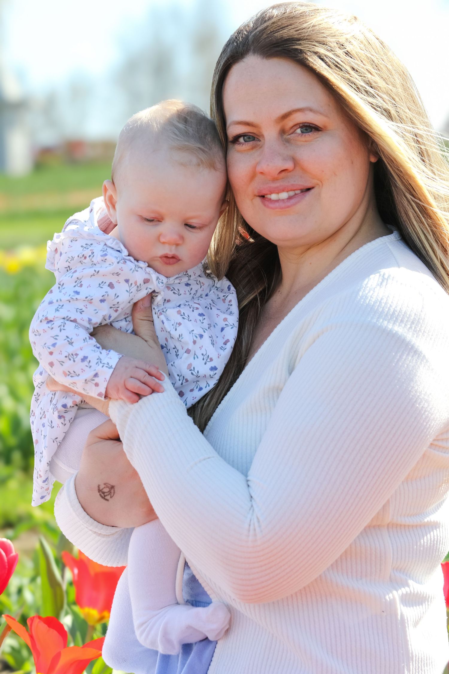 family moments shared among colorful tulips in a spring garden. Coventry and Warwickshire Photographer. Mothers Day Mini Sessions