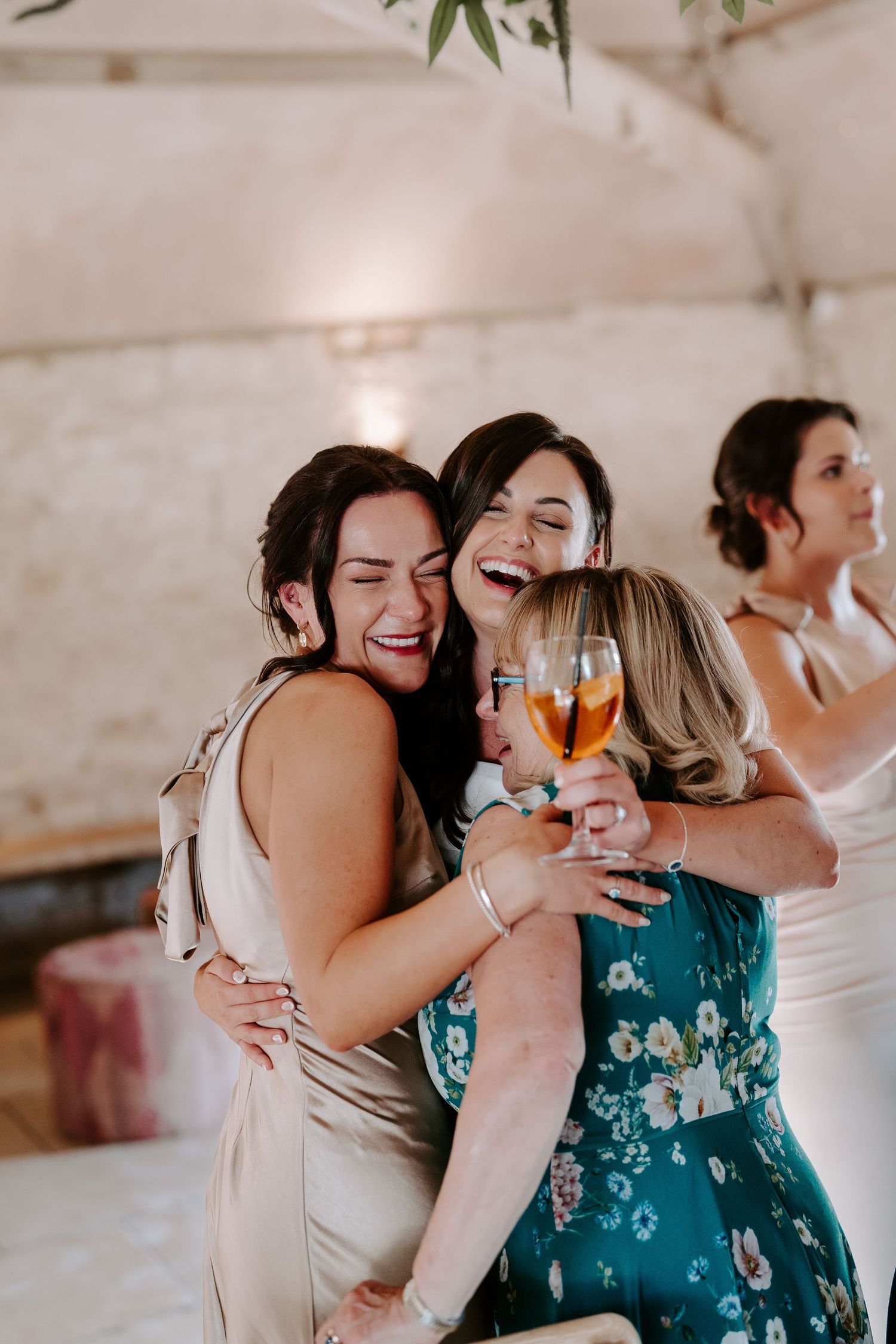 bride hugging mum and bridesmaid at yardspace old gore Cirencester