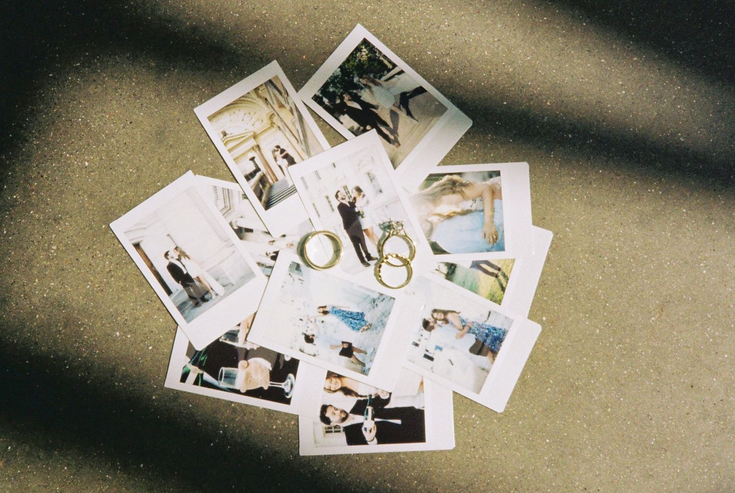A collection of wedding polaroid photos scattered on a surface, featuring couples in formal attire with gold ring decorations.