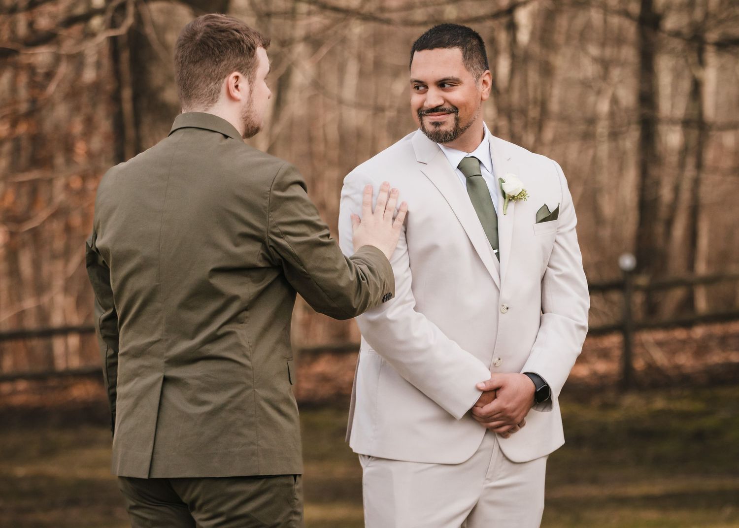 Groom tapping partner on shoulder during first look at Briar Barn Inn wedding in Massachusetts